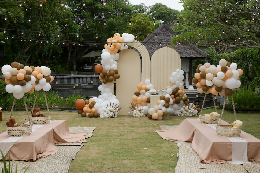 Beautiful outdoor garden venue with tables and decorations for baby shower celebration